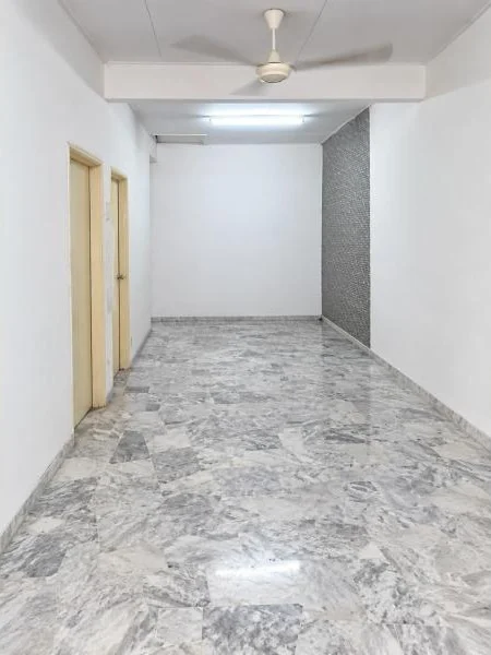 Hallway features: white painted walls, grey marble tile flooring, plain white ceiling, fluorescent tube ceiling light, white ceiling fan, two beige wooden doors, grey textured accent wall, long narrow corridor layout, smooth skirting boards; style: modern.