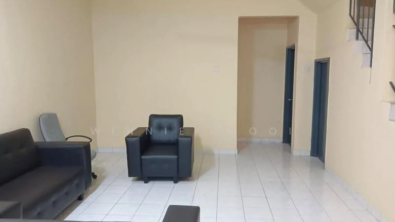 Living features: cream painted walls, white tiled flooring, 2-seater fabric sofa in grey, armchair in black, coffee table, wall-mounted shelves, doorway leading to another room, staircase visible in background.