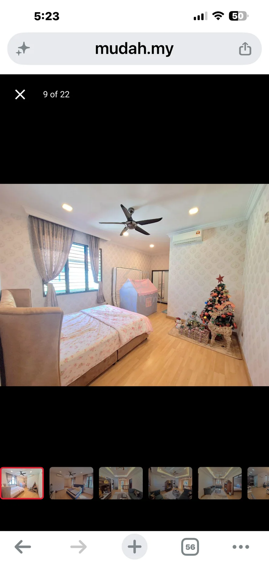 Bedroom features: queen-size bed with upholstered headboard, wooden flooring, light grey wallpaper with floral pattern, 5-blade ceiling fan with light, floor-to-ceiling window with sheer curtains, built-in wardrobe, decorative Christmas tree, area rug with geometric pattern, wall-mounted air conditioning unit, nightstand with lamp; style: modern.