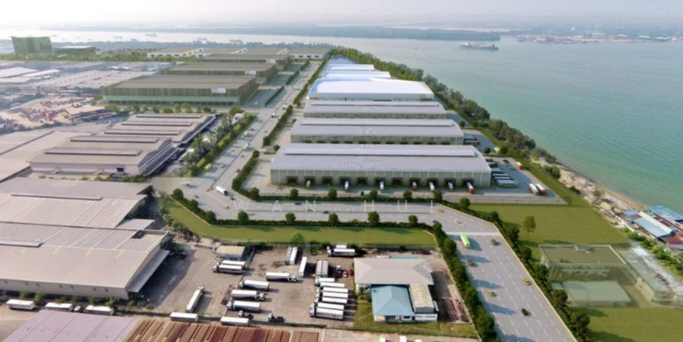 Exterior type: industrial complex; features: multiple warehouse buildings, loading docks, paved access roads, surrounding greenery, waterfront view, large parking area for trucks, open space for logistics operations, adjacent to shipping port; style: modern.