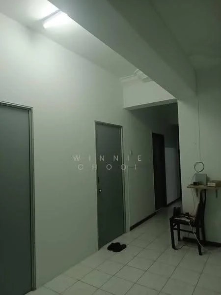 Room features: white painted walls, tile flooring, ceiling light fixture, two grey doors, wooden chair, small table, black slippers on floor.