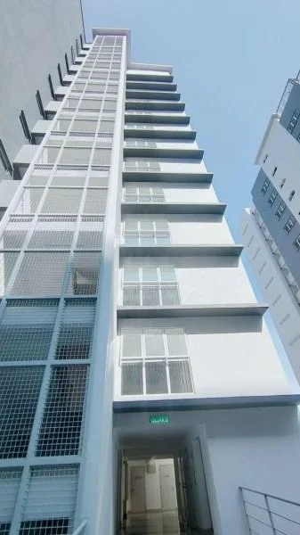 Exterior type: mid-rise condominium; features: white painted facade, glass curtain wall, recessed balconies, metal railing, approximately 10-storey high-rise, elevator access, intercom panel at entrance; style: modern.