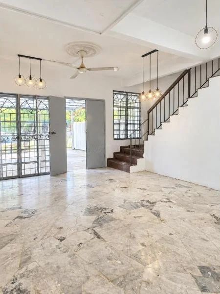 Hallway features: white painted walls, marble tile flooring, plain white ceiling, recessed ceiling border, ceiling fan, three pendant lights, single pendant light, metal security grilles on windows, glass front door, open doorway to exterior, staircase with dark wood treads, black metal stair railing, large windows, natural light; style: contemporary; view: garden.