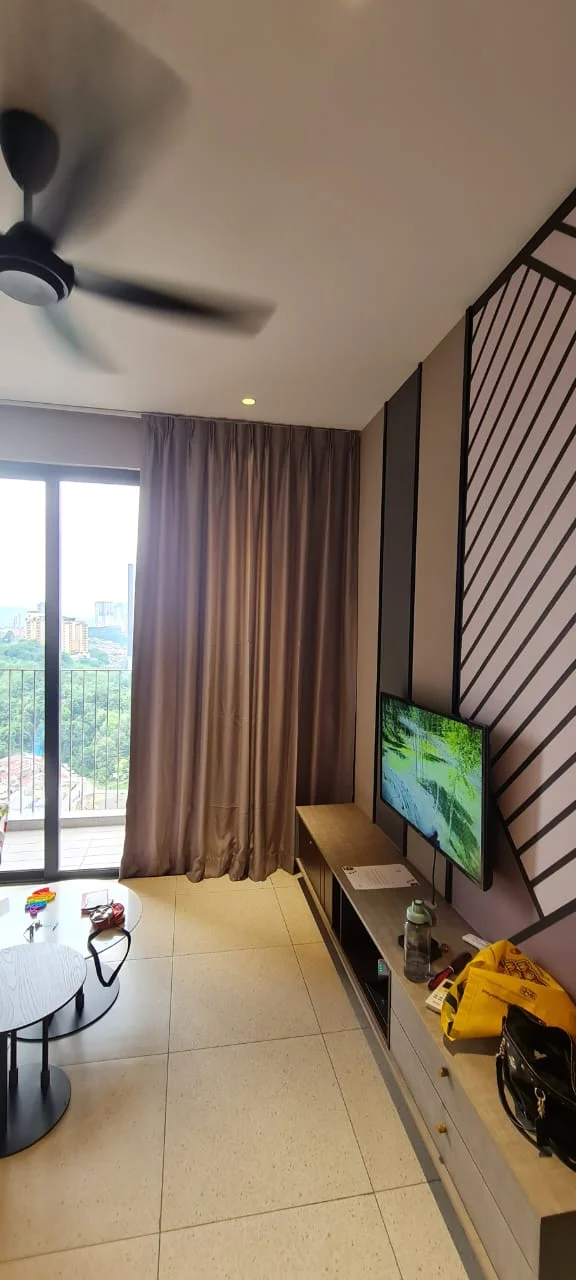 Living features: 5-blade ceiling fan with light, floor-to-ceiling windows, grey curtains, light-coloured wall with geometric pattern, dark accent wall, TV mounted on wall, wooden TV console, round coffee table, decorative items on table, ceramic flooring; style: modern; view: city.