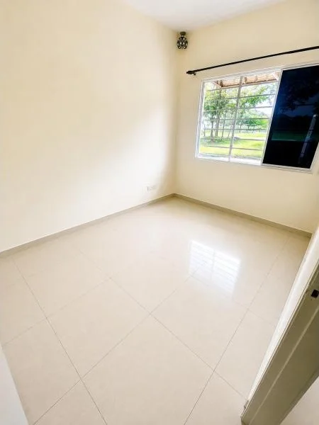 Bedroom features: white painted walls, cream painted walls, glossy light beige ceramic tile flooring, plain white ceiling, single window, sliding window with black frame, metal window grille, black curtain rod, natural light, corner wall-mounted light fixture, empty unfurnished room, doorway visible; style: minimalist; view: garden.