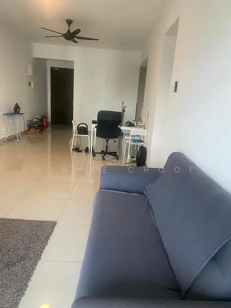 Living features: grey fabric sofa, area rug with geometric pattern, white painted walls, glossy tile flooring, ceiling fan, wall-mounted light switch, small side table, office desk with chair, computer monitor, stacked chairs, doorway leading to hallway; style: modern.