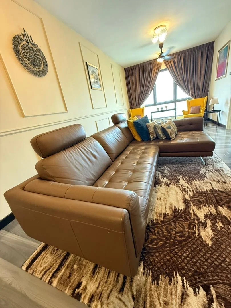 Living features: 3-seater leather sofa in brown, 2-seater leather sofa in brown, decorative cushions, area rug with geometric pattern, floor-to-ceiling windows, curtains, wall-mounted artwork, ceiling light fixture, wooden flooring, wall paneling; style: modern; view: city.