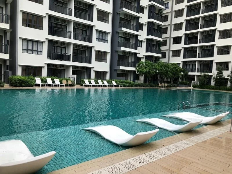 Exterior type: high-rise condominium; features: infinity pool, pool deck with loungers, surrounded by greenery, multiple storey building, balconies visible on upper floors, landscaped garden area; style: modern.