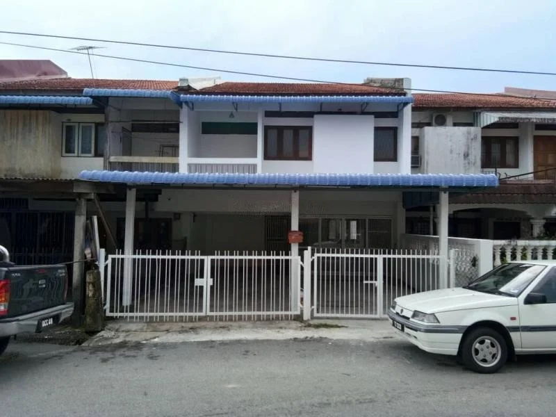 Exterior type: linked terrace house; features: blue tiled roof, white painted facade, front gate with white picket fencing, two-storey structure, balconies on the upper floor, ground floor parking area, concrete driveway, surrounded by residential buildings, visible street view; style: traditional.