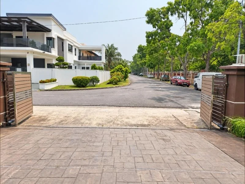 Exterior type: semi-detached house; features: double-storey, white painted facade, grey accent cladding, flat roof, projecting balconies, glass balcony railings, covered car porch, driveway with stamped concrete paving, gated entry, fronts a quiet residential street, mature trees, tropical landscaping, manicured shrubs; style: modern.