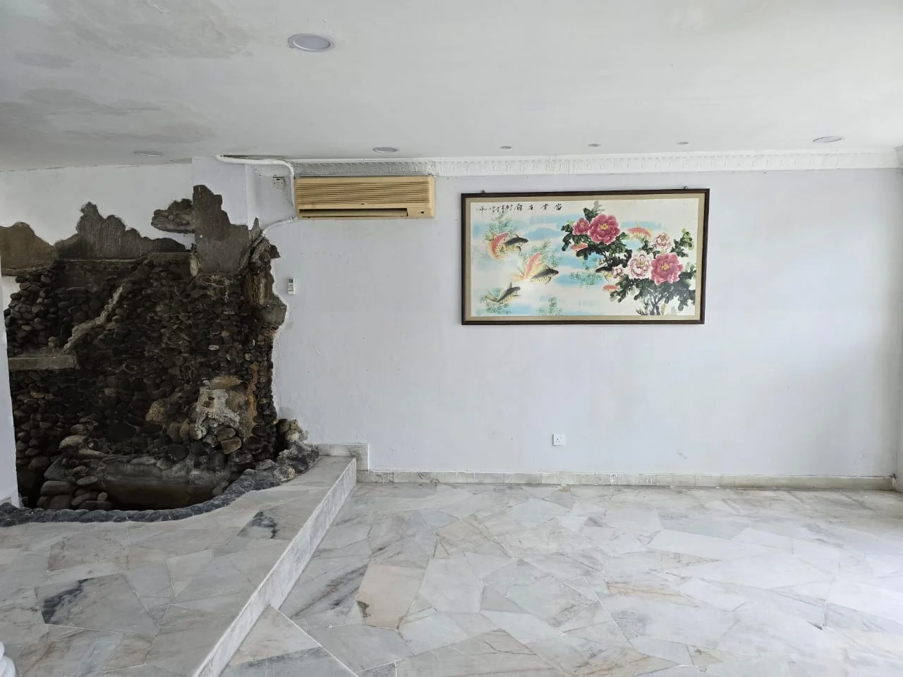 Room features: marble flooring, white painted walls, exposed stone feature wall, decorative wall art, wall-mounted air conditioning unit, recessed ceiling lights; style: modern.