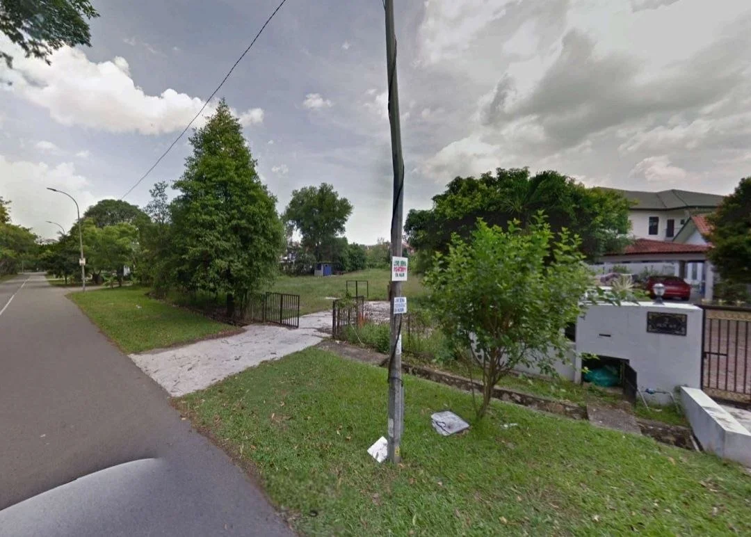 Exterior features: manicured lawn, mature trees, fenced property, paved walkway, street view, utility pole, roadside signage.