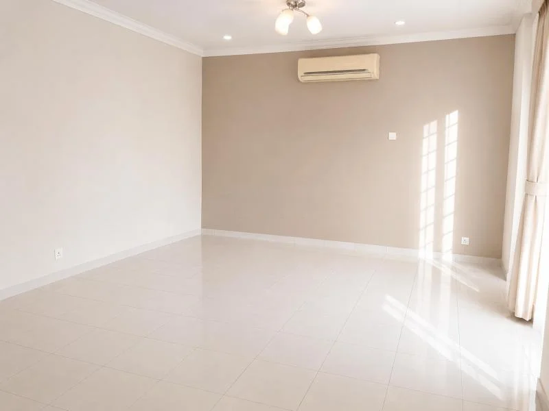 Living features: white painted walls, beige accent wall, white ceramic tile flooring, crown moulding, recessed downlights, 3-blade ceiling fan with light, wall-mounted split AC, floor-to-ceiling curtains, sliding glass door, sunlight through window, empty unfurnished room; style: contemporary.