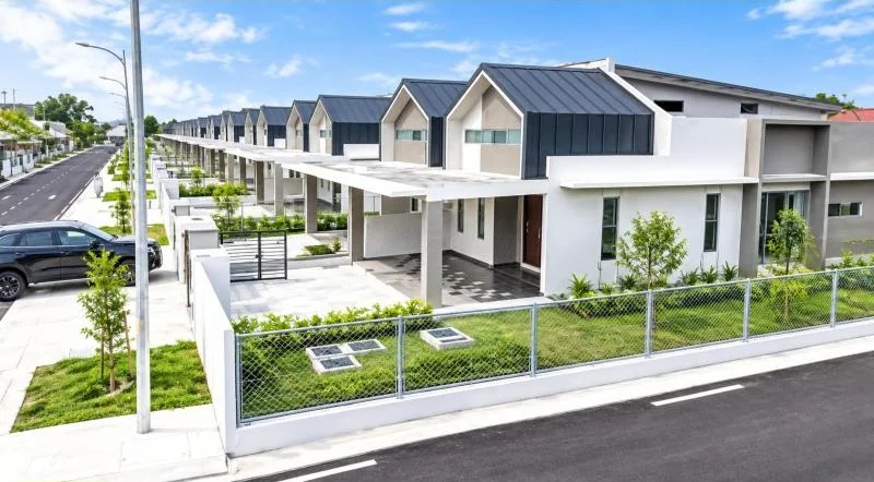 Exterior type: linked terrace house; features: double-storey, modern facade, white painted facade, dark grey metal roof, projecting gables, flat roof car porch canopy, covered car porch, driveway with interlocking pavers, front yard lawn, chain-link perimeter fence, gated entry, fronts a quiet residential street, street-side sidewalk, young landscaping, row of attached houses; style: modern.