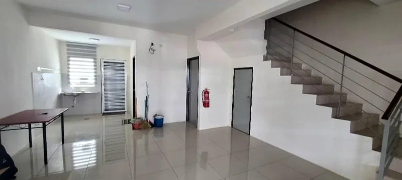 Room features: white painted walls, glossy tile flooring, staircase with metal railing, fire extinguisher mounted on wall, window with horizontal slats, door leading to unknown room, table with metal legs, cleaning supplies in blue bucket; style: modern.