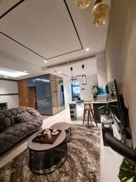 Living features: grey tufted sofa, round coffee table, area rug with geometric pattern, wall-mounted TV, TV console, pendant lighting, recessed ceiling lights, decorative plants, open layout to kitchen, white walls, crown moulding, sliding glass door, floor-to-ceiling windows; style: modern. Kitchen features: stainless-steel fridge, kitchen island, bar stools, wood cabinetry, black countertop, open shelving, pendant lights over island; style: modern.