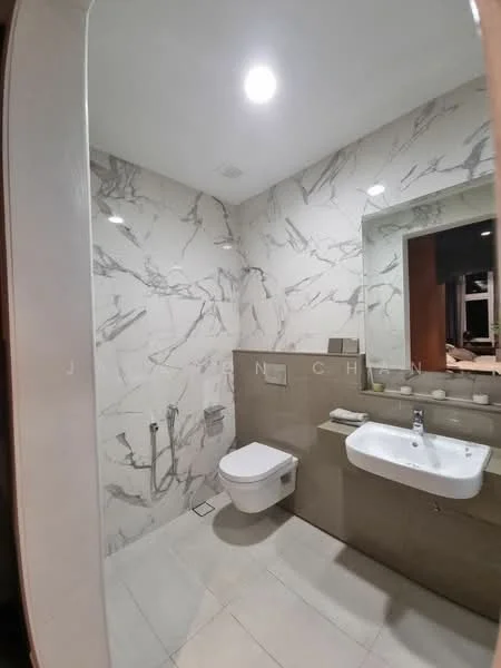 Bathroom features: white wall tiles with marble pattern, light beige floor tiles, single-sink vanity with wall-mounted cabinet, chrome basin mixer faucet, framed mirror above sink, one-piece toilet, bidet spray, recessed ceiling lights; style: modern.