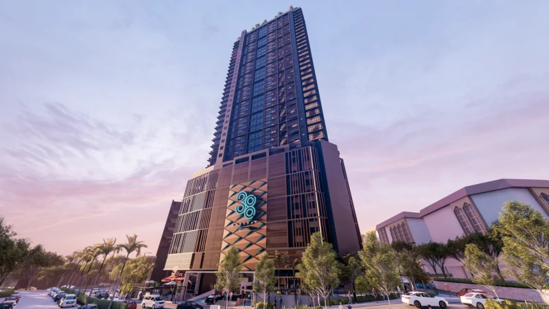 Exterior type: high-rise condominium; features: glass curtain wall, black metal cladding, recessed balconies, feature lighting at night, approximately 30-storey high-rise, manicured landscaping with palm trees, outdoor seating area, entrance with decorative facade; style: modern.